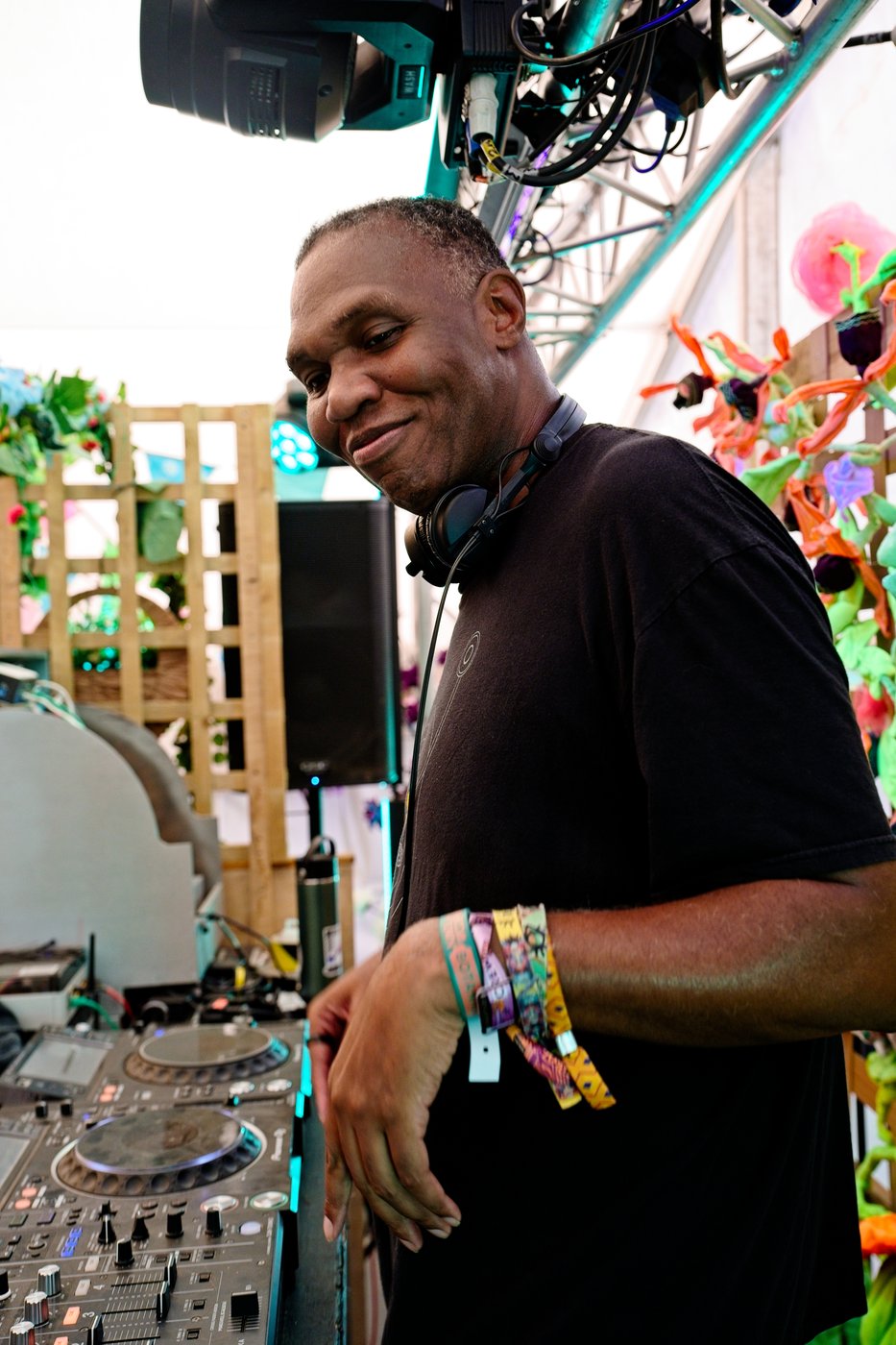 Rodderz smiling behind the decks at Boomtown Fair Garden Centre Stage 2026